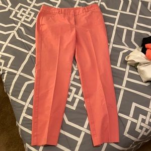 Coral colored dress slacks, ankle length.